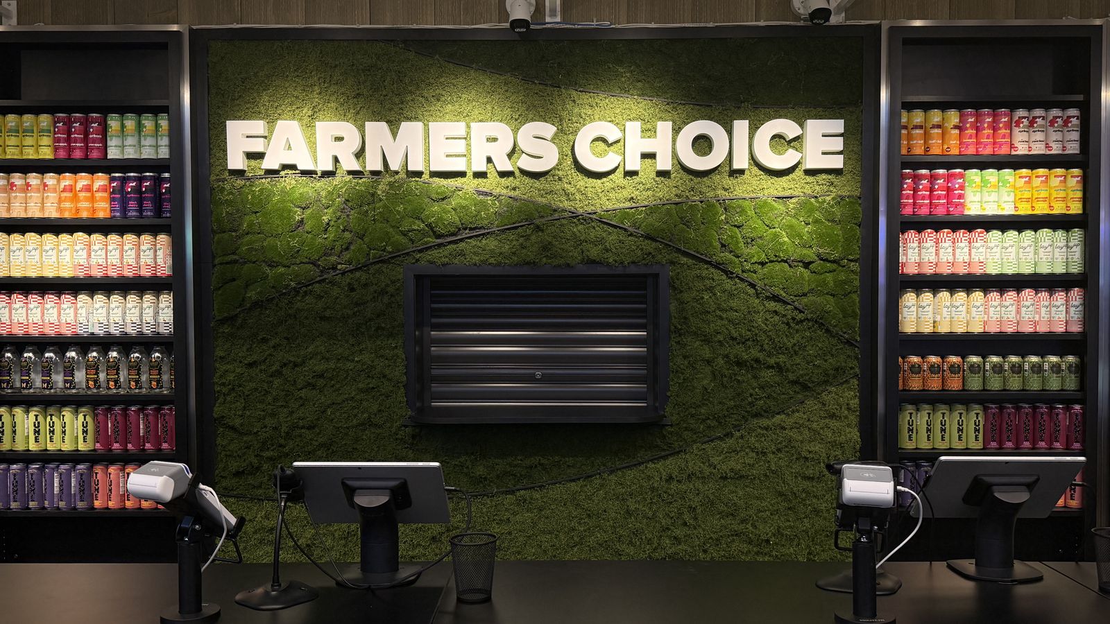 The moss wall and illuminated Farmers Choice sign inside the New Paltz dispensary